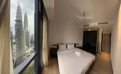 a bedroom with a white bed and a large window at Star Residence By M&T in Kuala Lumpur