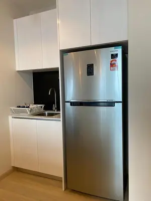 a stainless steel refrigerator in a kitchen with a sink at Star Residence By M&T in Kuala Lumpur