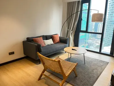 a living room with a couch and a table at Star Residence By M&T in Kuala Lumpur