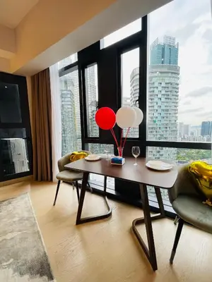 a living room with a table and chairs and a large window at Star Resident KLCC By M&T in Kuala Lumpur
