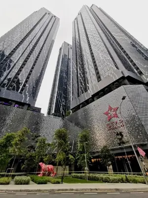 two tall buildings with a statue of a cow in front at Star Resident KLCC By M&T in Kuala Lumpur