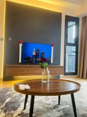 a living room with a coffee table and a tv at Star Resident KLCC By M&T in Kuala Lumpur
