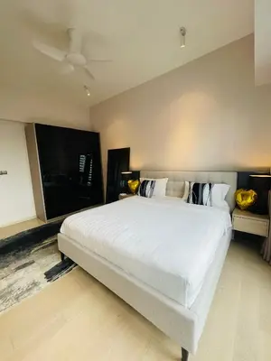 a bedroom with a large white bed and a flat screen tv at Star Resident KLCC By M&T in Kuala Lumpur