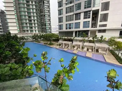 a large blue swimming pool in a city with buildings at Apartment at Robertson by Wgshomestay in Kuala Lumpur