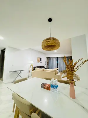 a living room with a white table and chairs at Eaton Service Apartment at KLCC in Kuala Lumpur