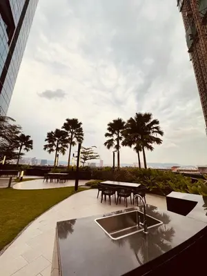 a patio with a sink and a table and some palm trees at Eaton Service Apartment at KLCC in Kuala Lumpur