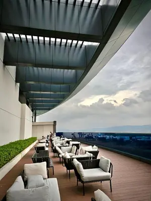 a row of chairs and tables on a building at Eaton Service Apartment at KLCC in Kuala Lumpur