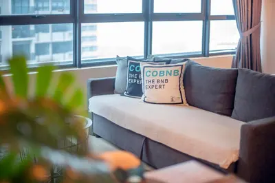 a couch with two pillows on it in a living room at Arte Plus Ampang Free Parking in Kuala Lumpur