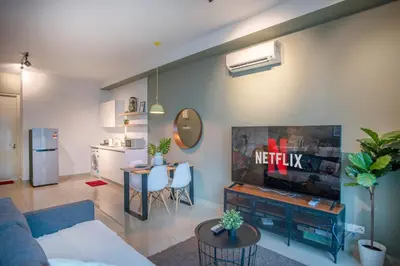 a living room with a couch and a tv and a table at Arte Plus Ampang Free Parking in Kuala Lumpur
