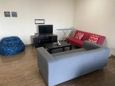 a living room with a couch and a tv at Ubays Zetepark House in Kuala Lumpur