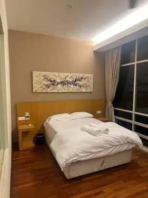 a bedroom with a bed and a painting on the wall at Luxzell suit KlCC-7minutes walk to KLCC in Kuala Lumpur