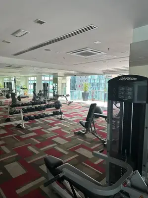 a gym with a lot of cardio equipment in a building at Luxzell suit KlCC-7minutes walk to KLCC in Kuala Lumpur