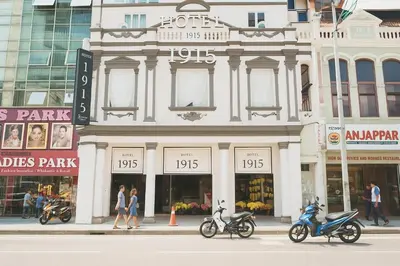 two scooters parked in front of a building on a street at Hotel 1915 Chinatown Kuala Lumpur in Kuala Lumpur