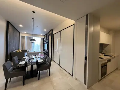 a dining room and living room with a table and chairs at Tropicana The Residences by uBook in Kuala Lumpur