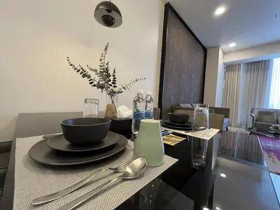 a dining room table with plates and spoons on it at Tropicana The Residences by uBook in Kuala Lumpur