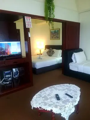a hotel room with two beds and a television at 1 Imbi Suites Times Square Bukit Bintang KL in Kuala Lumpur