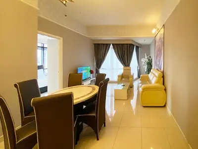 a living room with a dining room table and chairs at 1 Imbi Suites Times Square Bukit Bintang KL in Kuala Lumpur
