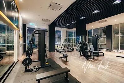 a gym with treadmills and ellipticals in a building at NaiBnB in Quill Residences in Kuala Lumpur