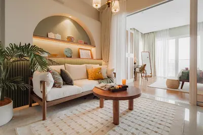 a living room with a white couch and a table at NaiBnB in Quill Residences in Kuala Lumpur