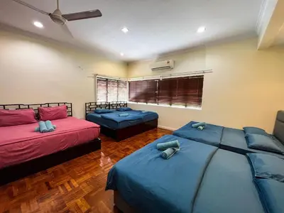 two beds in a room with blue sheets at Bukit Tunku Grande Villa by uBook in Kuala Lumpur