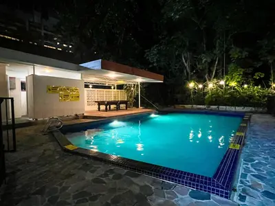 a swimming pool in a yard at night at Bukit Tunku Grande Villa by uBook in Kuala Lumpur