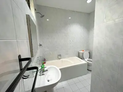 a bathroom with a sink and a tub and a toilet at Bukit Tunku Grande Villa by uBook in Kuala Lumpur