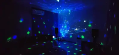 a room with blue and green lights on the ceiling at Bukit Tunku Grande Villa by uBook in Kuala Lumpur