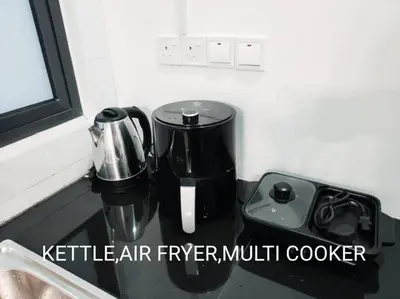 a kitchen counter with a coffee maker and a blender at Neu suites cozy 2 bedrooms family house in Kuala Lumpur