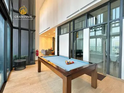 a pool table in the middle of a room with windows at Lucentia BukitBintang KlccView InfinityPool By HeyStay Management in Kuala Lumpur