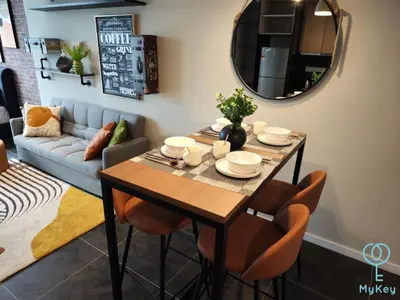 a dining room with a table and a couch at Scarletz Starlight Suites KLCC in Kuala Lumpur