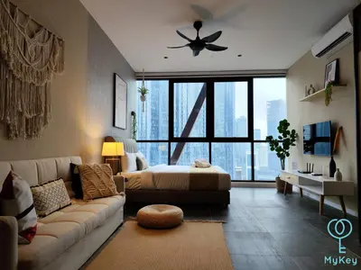 a living room with a couch and a bed at Scarletz Starlight Suites KLCC in Kuala Lumpur