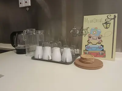 a counter top with a group of glasses and plates at Cozy Suite to NEXUS n LifeCare Med in Kuala Lumpur