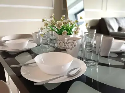 a glass table with bowls and spoons on it at Cozy Suite to NEXUS n LifeCare Med in Kuala Lumpur