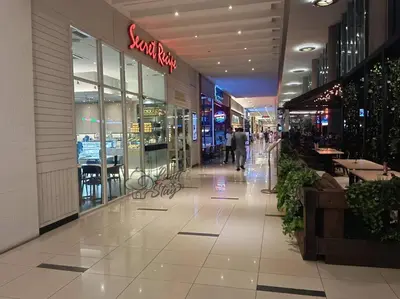 a shopping mall with a person walking down the aisle at Cozy Suite to NEXUS n LifeCare Med in Kuala Lumpur