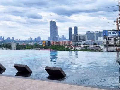 a large pool of water with a city in the background at Luxury Spacious 4 Bedroom Suite - Cheras Maluri MRT in Kuala Lumpur