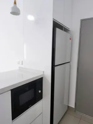 a kitchen with a black and white refrigerator at Luxury Spacious 4 Bedroom Suite - Cheras Maluri MRT in Kuala Lumpur