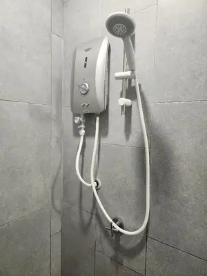 a hair dryer on a wall in a bathroom at Luxury Spacious 4 Bedroom Suite - Cheras Maluri MRT in Kuala Lumpur