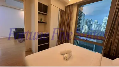 a room with a bed with a view of a city at SG Residence Kuala Lumpur by Fortune Suites in Kuala Lumpur