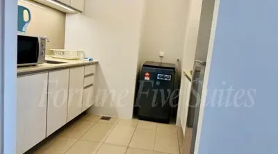 a kitchen with a refrigerator and a microwave at SG Residence Kuala Lumpur by Fortune Suites in Kuala Lumpur