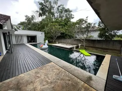 a backyard with a pool and a wooden deck at KL PJ Garden Pool Villa Karaoke in Petaling Jaya