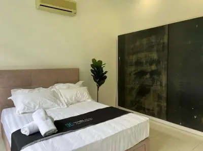 a bedroom with a bed with towels on it at KL PJ Garden Pool Villa Karaoke in Petaling Jaya