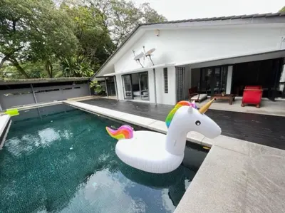 a pool with a unicorn float in front of a house at KL PJ Garden Pool Villa Karaoke in Petaling Jaya