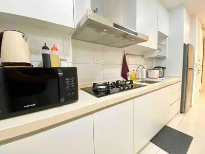 a white kitchen with a microwave and a stove at Robertson Bukit Bintang in Kuala Lumpur