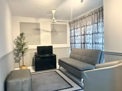 a living room with a couch and a television at 3BR at Pantai HillPark near University Malaya Mid Valley in Kuala Lumpur
