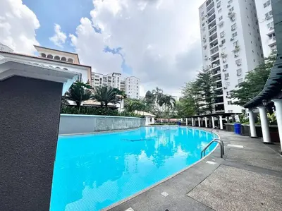 a large blue swimming pool next to a building at 3BR at Pantai HillPark near University Malaya Mid Valley in Kuala Lumpur