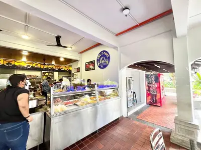 a woman standing in front of a counter in a bakery at 3BR at Pantai HillPark near University Malaya Mid Valley in Kuala Lumpur