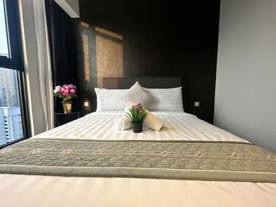 a bedroom with a large bed with flowers on it at Axon Residence Suites KL in Kuala Lumpur