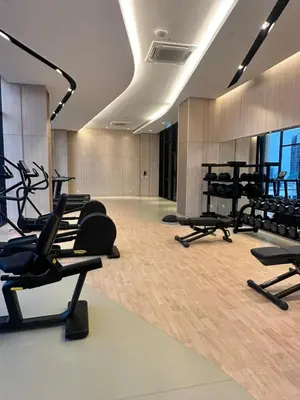 a gym with several treadmills and cardio machines at Axon Residence Suites KL in Kuala Lumpur