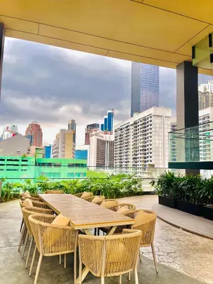 a table and chairs with a view of the city at Axon Residence Suites KL in Kuala Lumpur