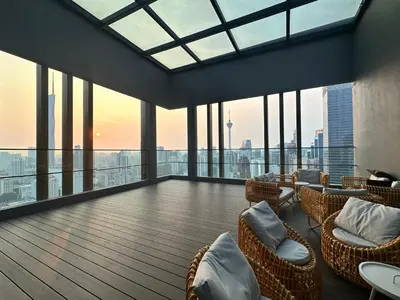 a large room with chairs and tables and windows at Axon Residence Suites KL in Kuala Lumpur